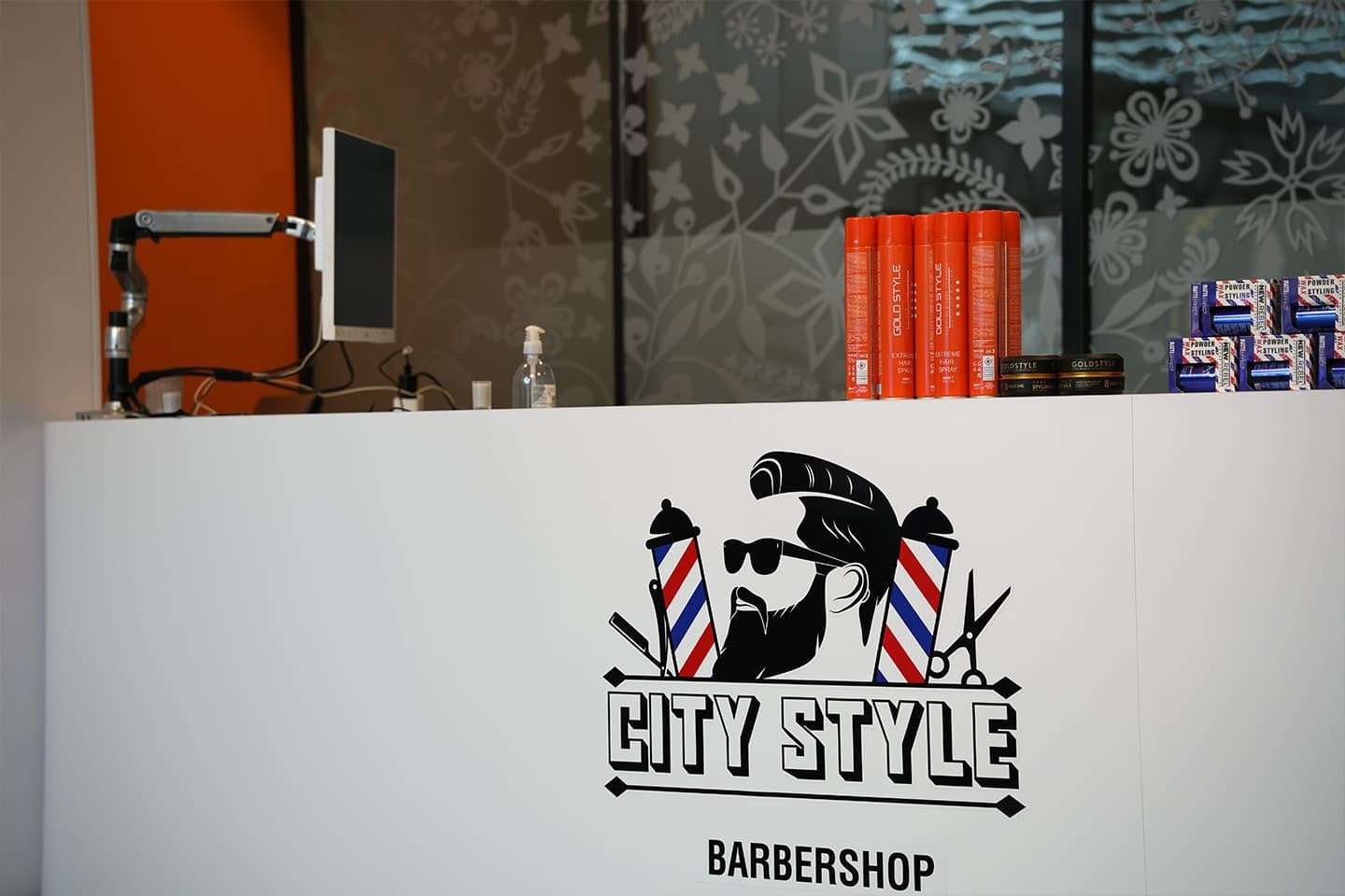 Witte receptiebalie met het City Style-logo en stylingproducten